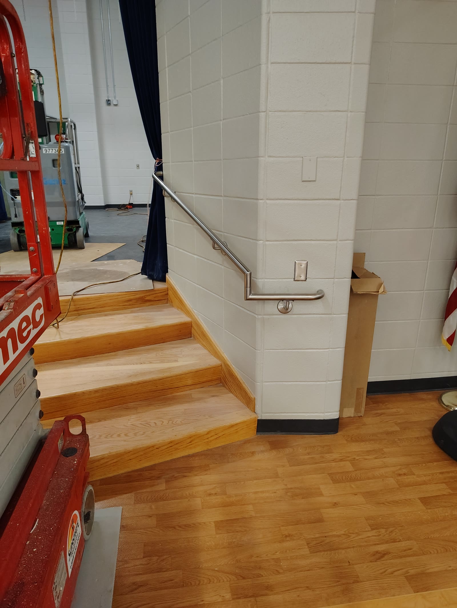 Stainless steel handrail along wooden stairs